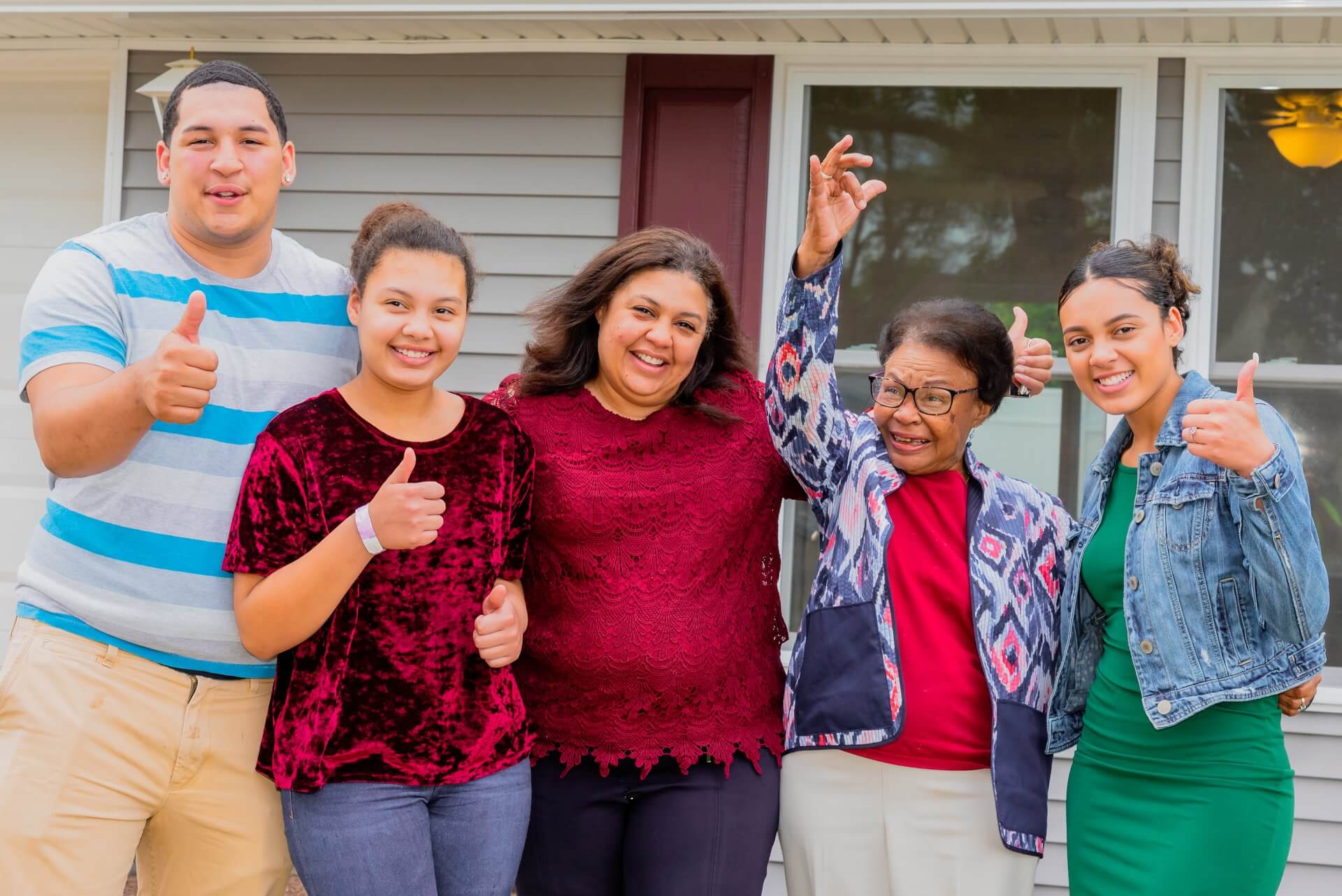 A family in front of their new home