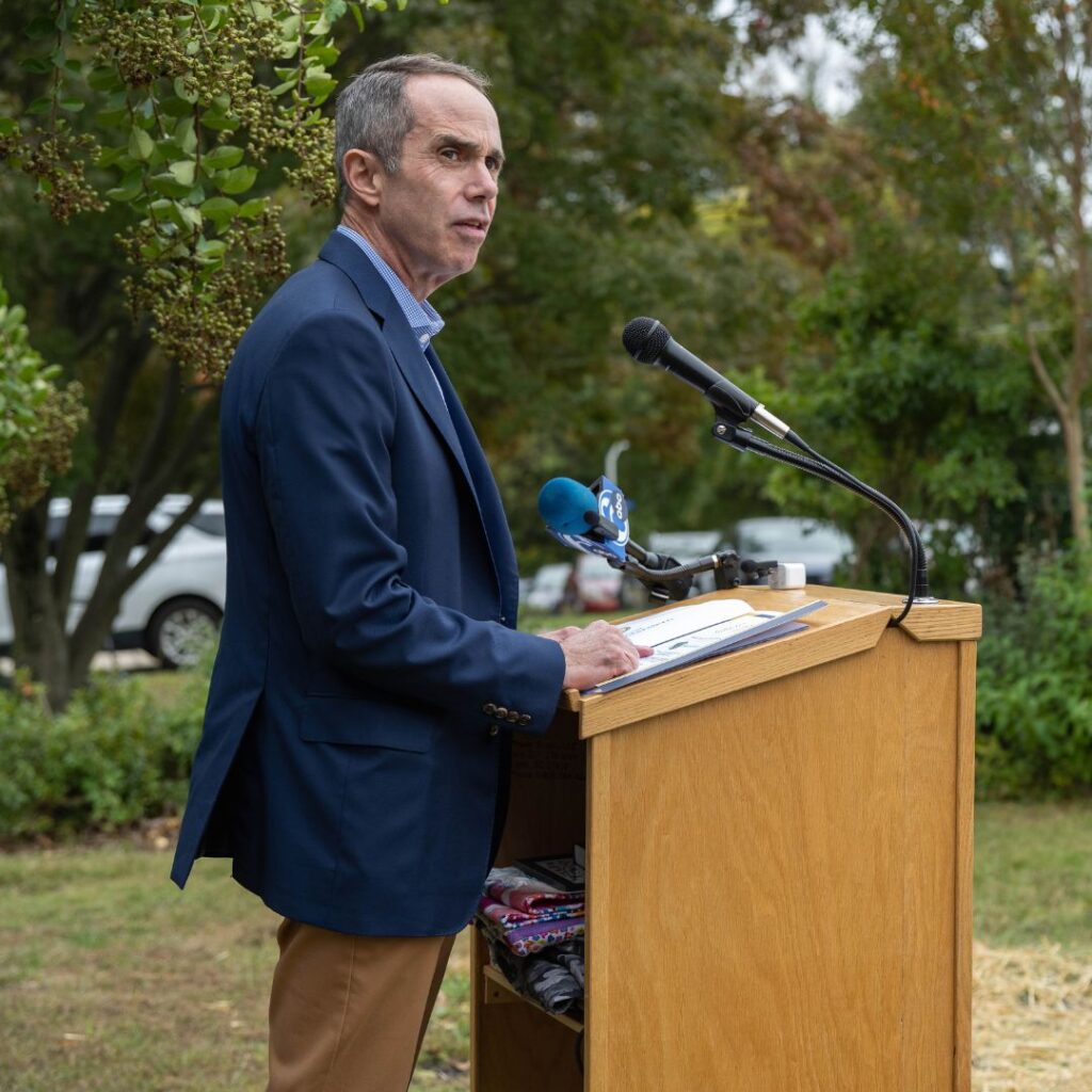 Person in blue blazer speaking at podium