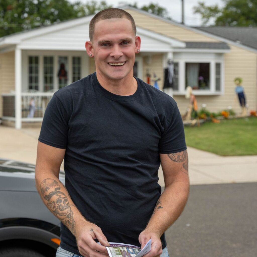 person in black tshirt smiling